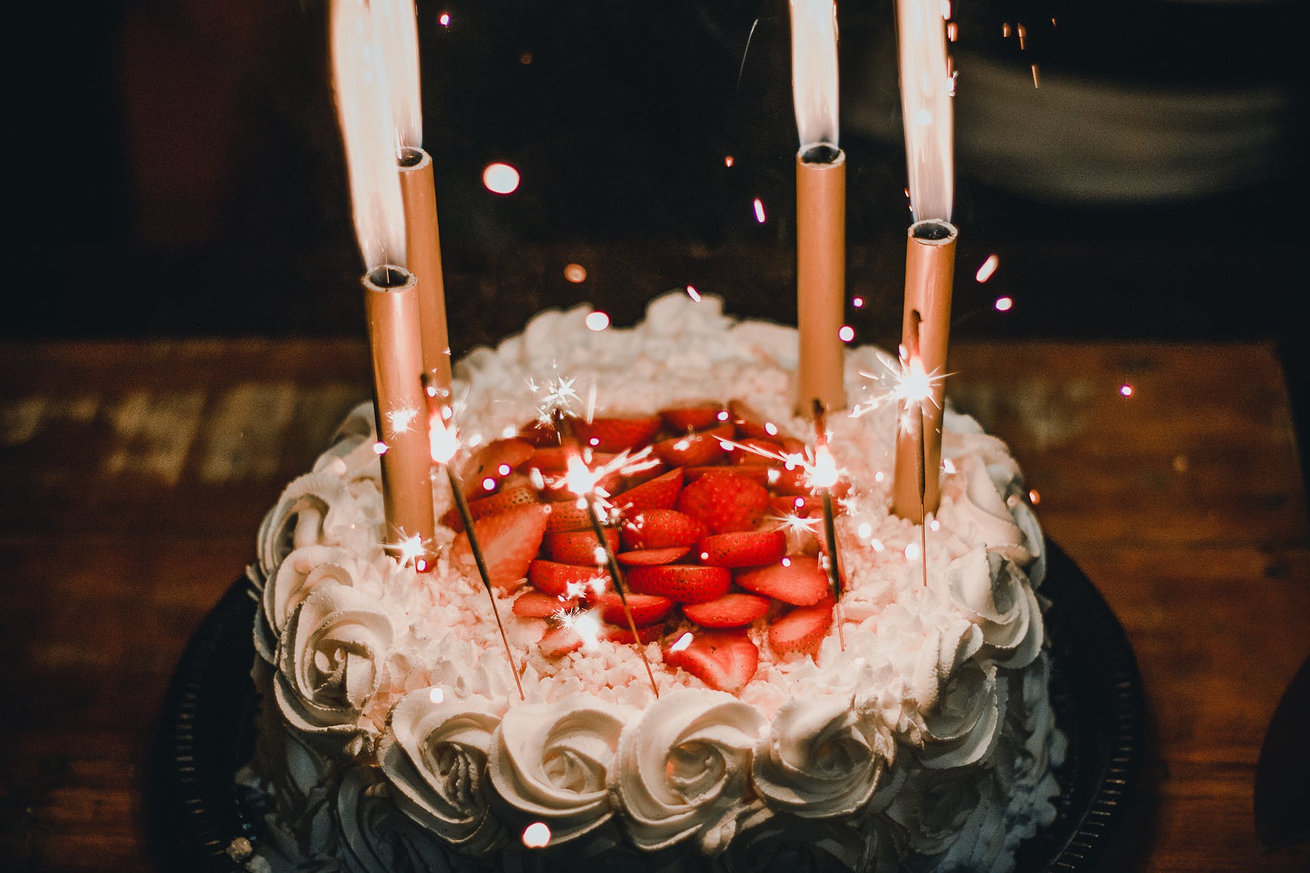 lighted candles on white icing covered cake